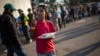 Dennis Mauricio Suarez, 12, from Honduras, eats breakfast at the Jesus Martinez stadium in Mexico City, Nov. 7, 2018. 