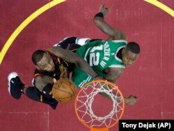 FILE - Cleveland Cavaliers' LeBron James, left, drives to the basket against Boston Celtics' Terry Rozier in the second half of Game 3 of the NBA basketball Eastern Conference finals Saturday, May 19, 2018, in Cleveland.