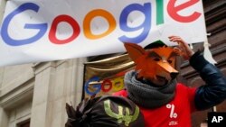 Activists from anti-globalization organisation Attac stage a protest at Google's Paris headquarters to criticize the company's tax evasion policies, in Paris, Jan. 31, 2019.