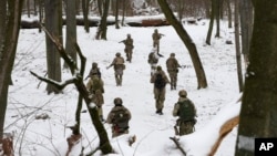 Members of Ukraine's Territorial Defense Forces, volunteer military units of the Armed Forces, train in Kyiv, Ukraine, Jan. 22, 2022. Dozens of civilians have been joining Ukraine's army reserves in recent weeks amid fears about Russian invasion.