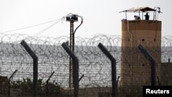 A member of Egypt's security forces stands on a watchtower in North Sinai as seen from across the border in southern Israel, July 1, 2015.