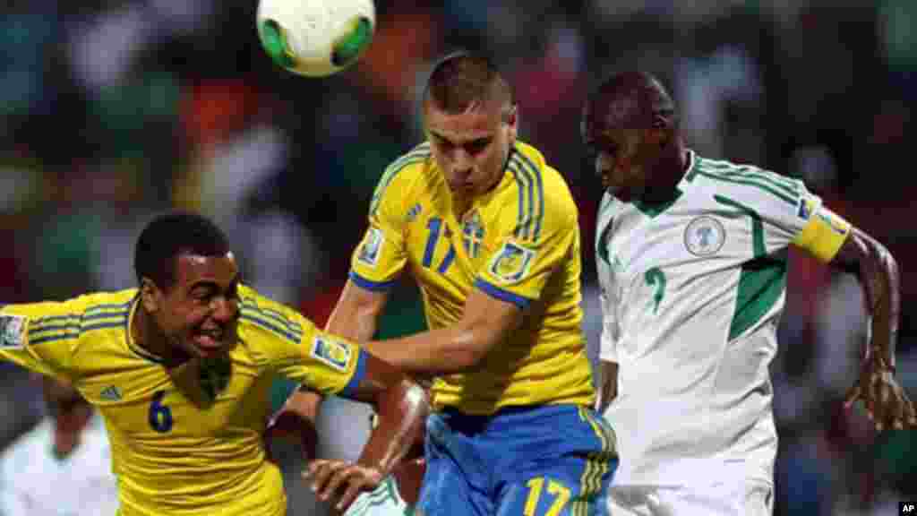 Noah Sonko and Mirza Halvadzic of Sweden vies for the ball against Musa Muhammed of Nigeria during a semifinal match of the World Cup U-17 in Dubai.