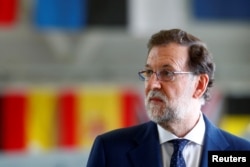 FILE - Spain's Prime Minister Mariano Rajoy speaks to media in Amari air base, Estonia, July 17, 2017.