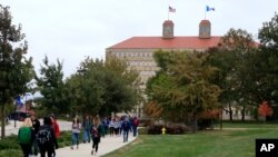 FILE - In this Oct. 24, 2019, photo, students walk in front of Fraser Hall on the University of Kansas campus in Lawrence, Kan.