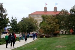 FILE - In this Oct. 24, 2019, file photo students walks in front of Fraser Hall on the University of Kansas campus in Lawrence, Kan.