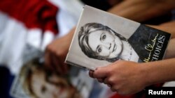 FILE - A supporter holds the book "Hard Choices" by then Democratic U.S. presidential candidate Hillary Clinton at a campaign event at the North Carolina State Fairgrounds in Raleigh, North Carolina, June 22, 2016.