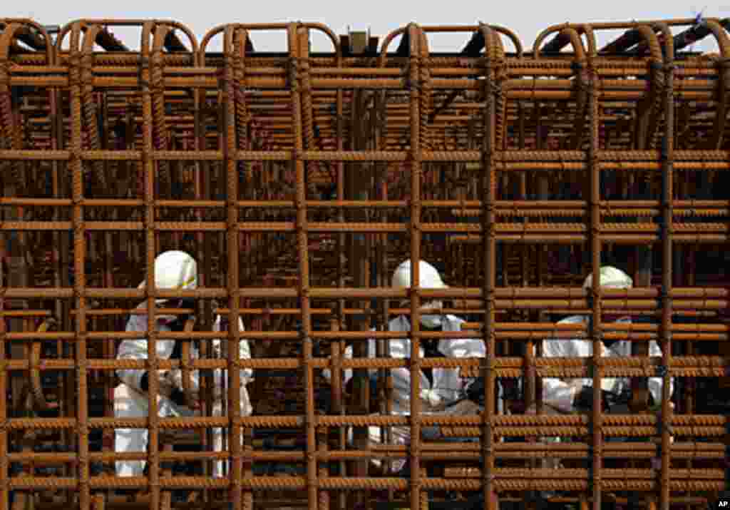 Preparation of rebar cages that will used for lifting tower foundations. The lifting towers setting on these foundations will raise the arch during erection, (VOA - D. Markosian, April 2011)