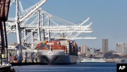 FILE - A container ship is moored at the Port of Seattle's seaport on the Duwamish Waterway, south of downtown Seattle, Nov. 11, 2014.