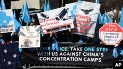 FILE - Uighurs and their supporters rally across the street from United Nations headquarters in New York, March 15, 2018. Members of the Uighur Muslim ethnic group held demonstrations in cities around the world on Thursday to protest a sweeping Chinese surveillance and security campaign that has sent thousands of their people into detention and political indoctrination centers.