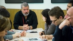 FILE - Dmitry Muratov, the editor of Novaya Gazeta, center left, attends a planning meeting with the editorial board, Oct. 9, 2015, in Moscow, Russia.