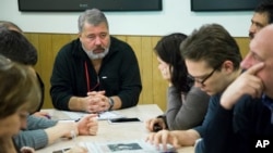 FILE - Novaya Gazeta editor-in-chief, center left, Dmitry Muratov attends a planning meeting with the editorial board, October 9, 2015, in Moscow, Russia.