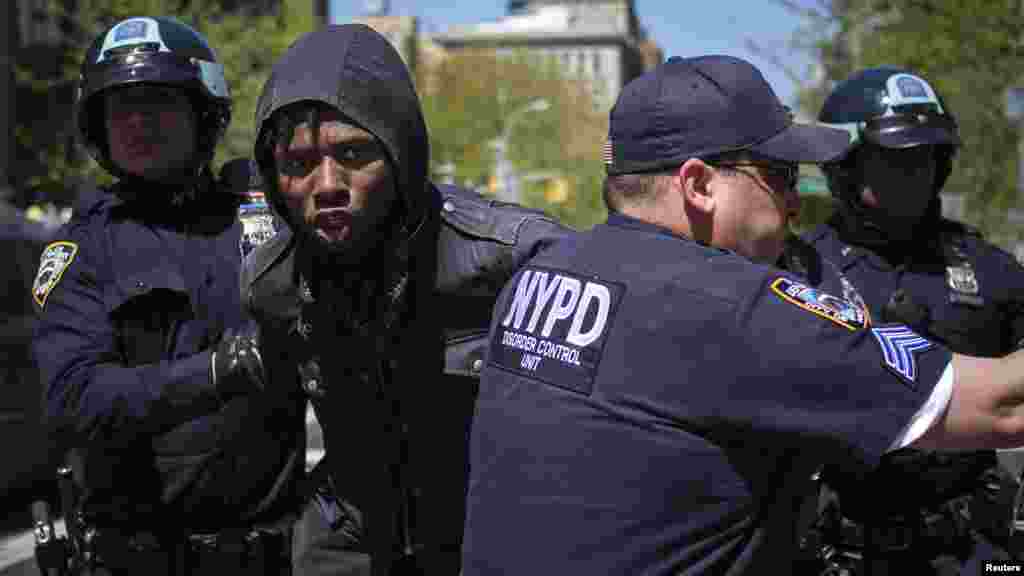 A demonstrator is arrested by New York Police Department officers during May Day rallies in New York, May 1, 2013.