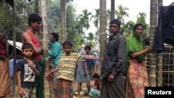 FILE - Rohingya refugees from Myanmar are seen outside their makeshift homes near Kutapalong refugee camp in the Cox's Bazar district of Bangladesh, Feb. 9, 2018.