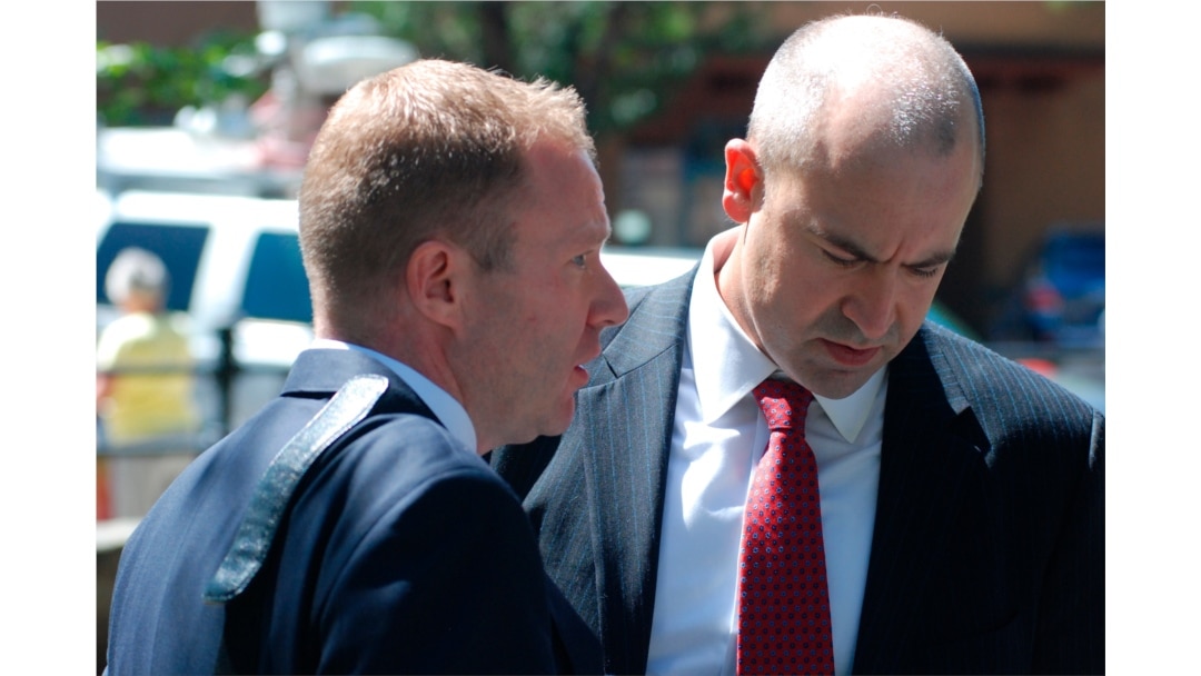 U.S. Attorney John Anderson, right, and federal prosecutor Sean Sullivan converse after a former Roman Catholic priest who fled the country decades ago was sentenced to 30 years in prison, Sept. 13, 2019, in Santa Fe, N.M.