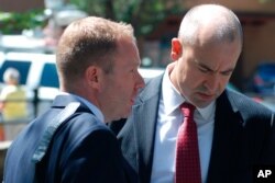 U.S. Attorney John Anderson, right, and federal prosecutor Sean Sullivan converse after a former Roman Catholic priest who fled the country decades ago was sentenced to 30 years in prison, Sept. 13, 2019, in Santa Fe, N.M.