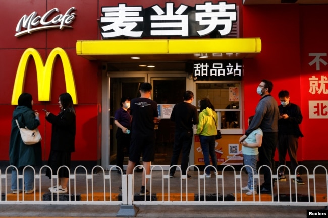 People wait for their orders outside a McDonald's restaurant, after the government banned dine-in services, following the coronavirus disease (COVID-19) outbreak in Beijing, China May 2, 2022. (REUTERS/Carlos Garcia Rawlins)