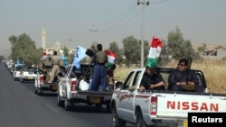 A military convoy drives towards Kirkuk, to reinforce Kurdish Peshmerga troops in Kirkuk, in this photograph taken through a window June 24, 2014.