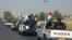 A military convoy drives towards Kirkuk, to reinforce Kurdish Peshmerga troops in Kirkuk, in this photograph taken through a window June 24, 2014.