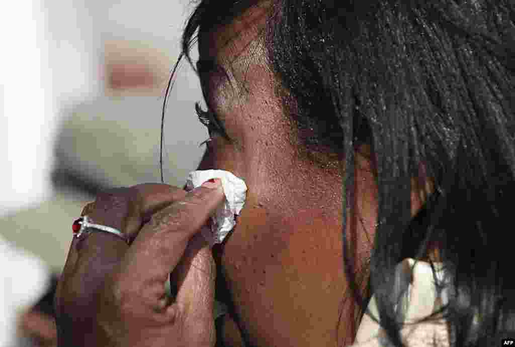 A woman wipes away a tear as she watches the funeral of Whitney Houston near the Hope Baptist Church in Newark, New Jersey February 18, 2012. Houston died February 11 in Beverly Hills, California, at the age 48. (REUTERS)