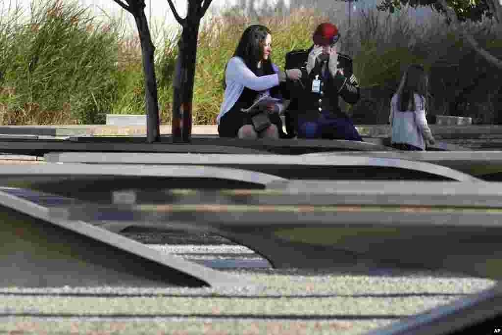 West Virginia National Guard Staff Sgt. Sean Ruth, center, mourns the loss of his father, Army Chief Warrant Officer Ford, at the September 11th Pentagon Memorial, Sept. 11, 2017.