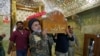 FILE - Mourners carry the coffin of a member of the Popular Mobilization Forces, who was killed in clashes with Islamic State militants in Salahuddin province, during the funeral in the holy city of Najaf, Iraq, May 3, 2020.