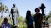 FILE - An interview is conducted next to a statue of Junipero Serra at the Carmel Mission in Carmel-By-The-Sea, Calif., Sept. 23, 2015. 