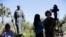 FILE - An interview is conducted next to a statue of Junipero Serra at the Carmel Mission in Carmel-By-The-Sea, Calif., Sept. 23, 2015. 