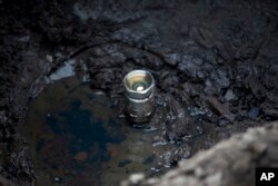 This July 11, 2017 photo shows an illegal tap into a state-owned pipeline created by fuel thieves in the middle of a cornfield in San Bartolome Hueyapan, Tepeaca, Mexico.