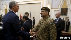 FILE - A member of U.S. delegation (L) shakes hand with a member of Pakistani delegation before a meeting in Kabul, Afghanistan, January 18, 2016. Pakistani officials are particularly furious at a Congressional hearing last week in Washington under the title “Pakistan: Friend or foe.”