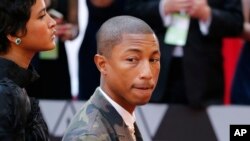 FILE - Pharrell Williams arrives at the Oscars on Feb. 24, 2019, at the Dolby Theatre in Los Angeles, California.