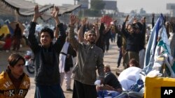 Supporters of the Tehreek-i-Labaik Ya Rasool Allah party chant religious slogans during a sit-in protest at an entrance to Islamabad, Pakistan, Nov. 26, 2017.