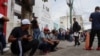 Migrants, mostly Venezuelans, wait outside Mexico's National Migration Institute to request repatriation flights after the cancellation of U.S. Customs and Border Protection CBP One appointments, in Tuxtla Gutierrez, Mexico, Feb. 20, 2025. 