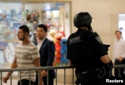 A New York Police Department officer stands guard in Grand Central Station following the Nice terror attack, in New York City, July 15, 2016.