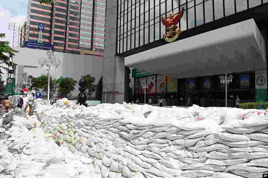Workers moving sandbags on a massive sandbag wall on Bangkok's busy Phahonyothin Road, October 27, 2011. ( VOA - D. Schearf)