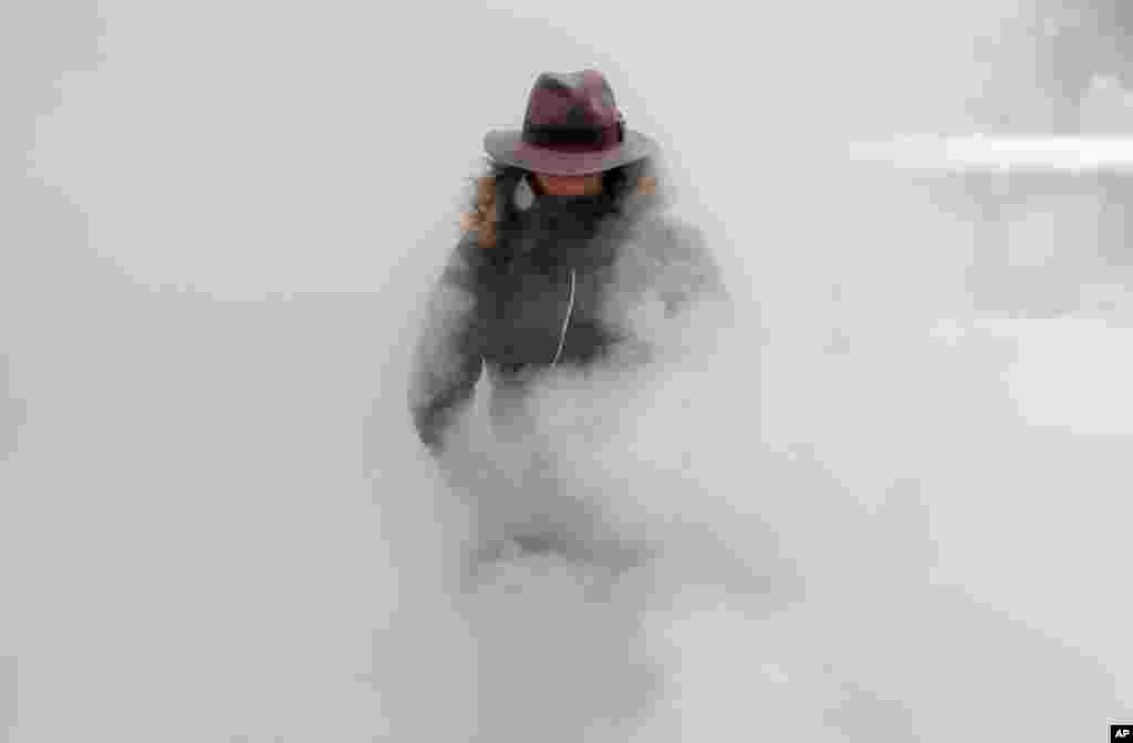 A woman walks through steam from an underground ventilation, as temperatures dropped below -20&deg;C (- 4&deg;F) in Bucharest, Romania.