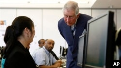 Britain's Prince Charles talks to a computer student at the Carlos Rosario International Public Charter School for Adults in Washington, March 19, 2015. 