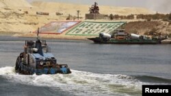 Security personnel cross through the New Suez Canal, Ismailia, Egypt, July 29, 2015.