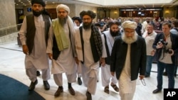 Mullah Abdul Ghani Baradar, the Taliban group's top political leader, third from left, arrives with other members of the Taliban delegation for talks in Moscow, Russia, May 28, 2019. 