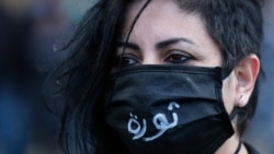 An anti-government protester wearing a mask to help curb the spread of the coronavirus with Arabic that reads, "Revolution," attends a protest against the deepening financial crisis, in Beirut, Lebanon, Monday, April 27, 2020. Photo: AP