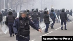 Riot police officers patrol in a street as unprecedented protests over a hike in energy prices spun out of control, in Almaty, Kazakhstan, Jan. 5, 2022. 