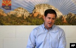 FILE - Arizona Gov. Doug Ducey speaks an event in Buckeye, Arizona, Aug. 14, 2017.