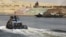 Security personnel cross through the New Suez Canal, Ismailia, Egypt, July 29, 2015.