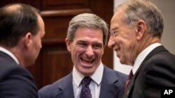 Former Virginia attorney general Ken Cuccinelli, center, is seen with lawmakers at the White House in Washington, Nov. 14, 2018.