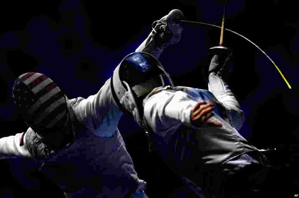 Tamas Meszaros (R) of Hungary and Race Imboden of United States fence during the men's team foil round of 16 match of the FIE World Fencing Championships in Budapest, Hungary.