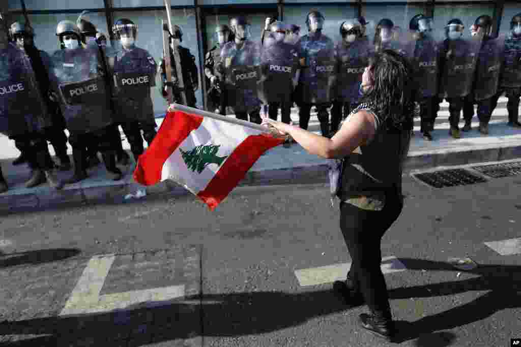 زن جوانی در بیروت پرچم لبنان را در مقابل نیروهای پلیس تکان می&zwnj;دهد. معترضان لبنانی به خیابان&zwnj;ها بازگشته&zwnj;اند. آنها به گرانی و وضعیت نامناسب اقتصادی اعتراض دارند.&nbsp;