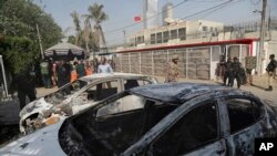 FILE - Pakistani security personnel move in the compound of Chinese Consulate following a deadly attack, in Karachi, Pakistan blamed on the Baluchistan Liberation Army, Nov. 23, 2018.