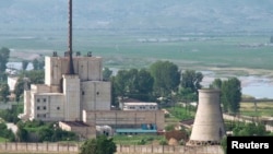 A North Korean nuclear plant is seen before demolishing a cooling tower (R) in Yongbyon, in this photo taken June 27, 2008 and released by Kyodo. North Korea is to restart the mothballed Yongbyon nuclear reactor that has been closed since 2007.