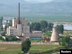 FILE - A North Korean nuclear plant is seen before demolishing a cooling tower (R) in Yongbyon, in this photo taken June 27, 2008, and released by Kyodo.