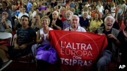 Supporters of left-wing Syriza party react as they watch the election results at the party’s main electoral center in Athens, Sunday, Sept. 20, 2015. 