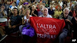 Supporters of left-wing Syriza party react as they watch the election results at the party’s main electoral center in Athens, Sunday, Sept. 20, 2015. 